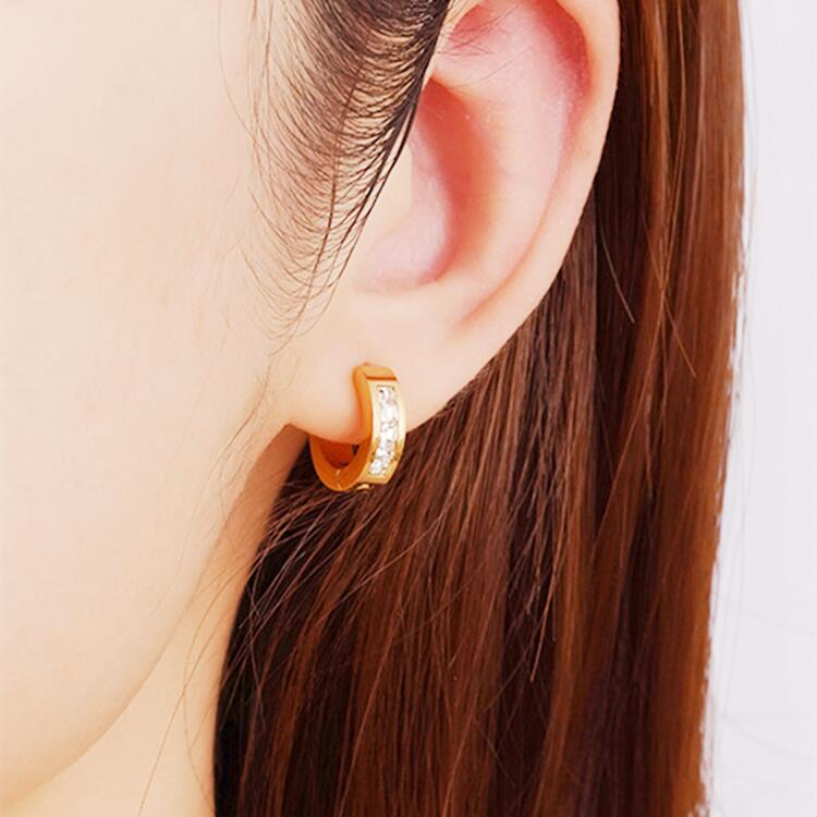 Gold Huggie Earrings on model